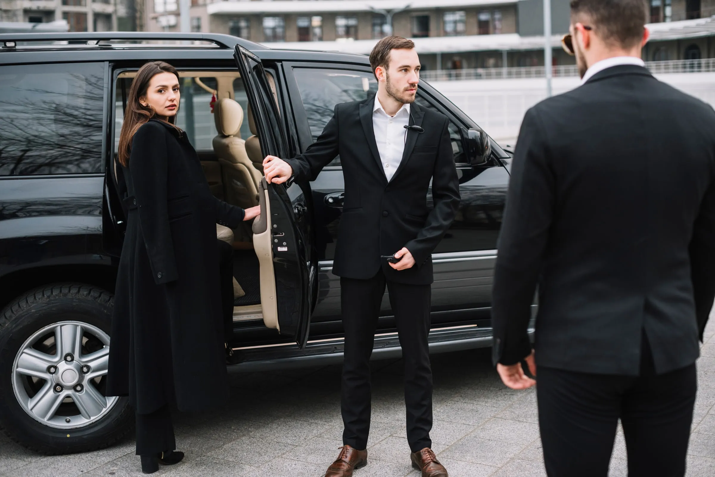 Best Eagle close-protection officer opening a vehicle door for a client